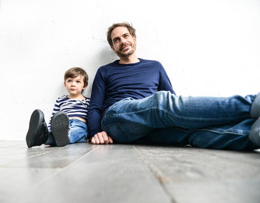 picture of a dad and young child sitting on the floor