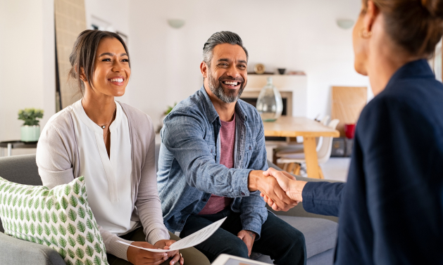 a financial advisor meeting with clients in their home