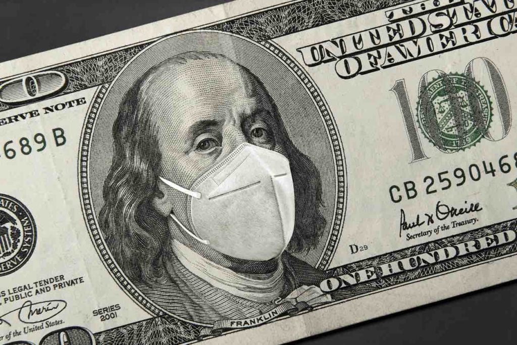 Picture of a 100 dollar bill with a face mask on Benjamin Franklin