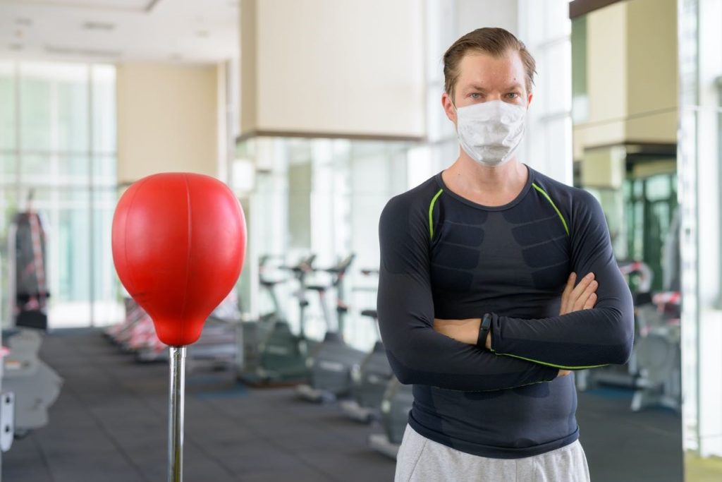 picture of a Man in a gym with face mask on