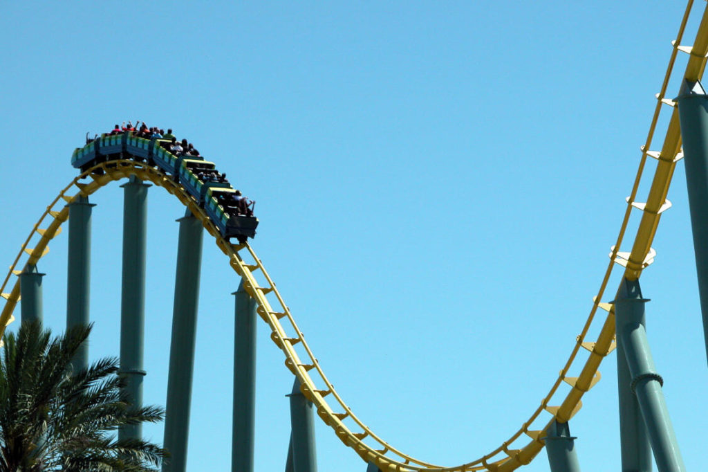 Roller coaster on a track going down briefly to go back up again