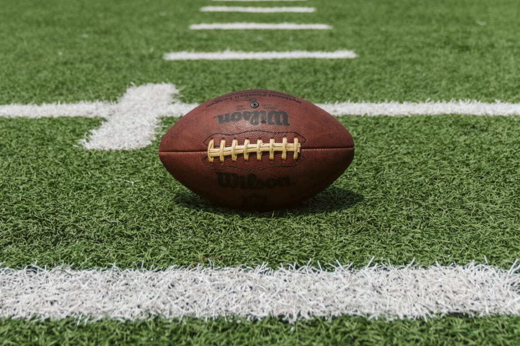 old football laying on a football field