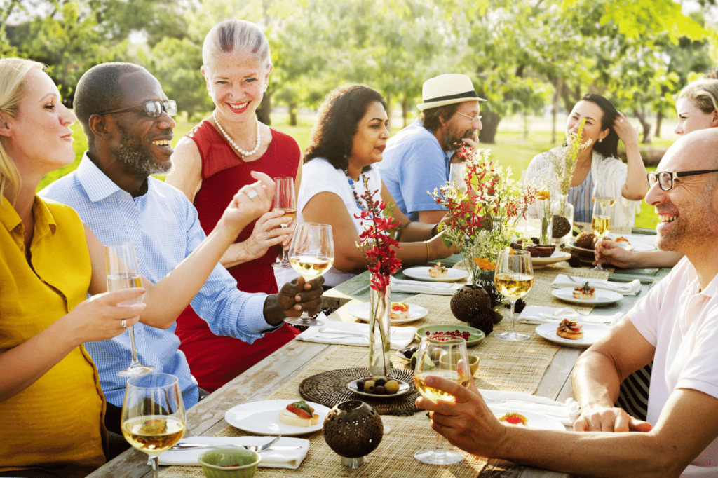 People sitting around a table enjoying an outdoor meal together