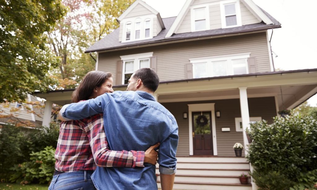 Rear View Of Loving Couple Walking Towards House