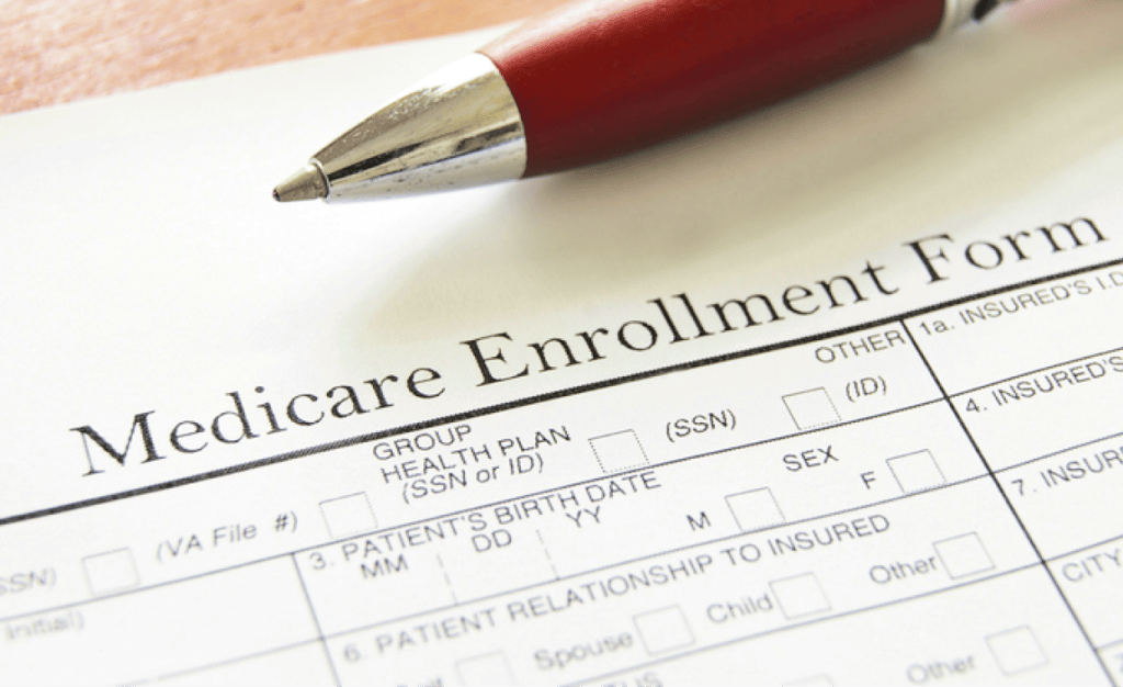 Closeup of Medicare enrollment form and pen