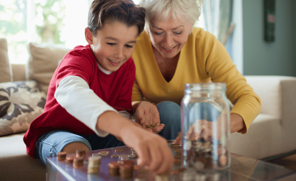 grandmother and grandchild counting change on a living room table