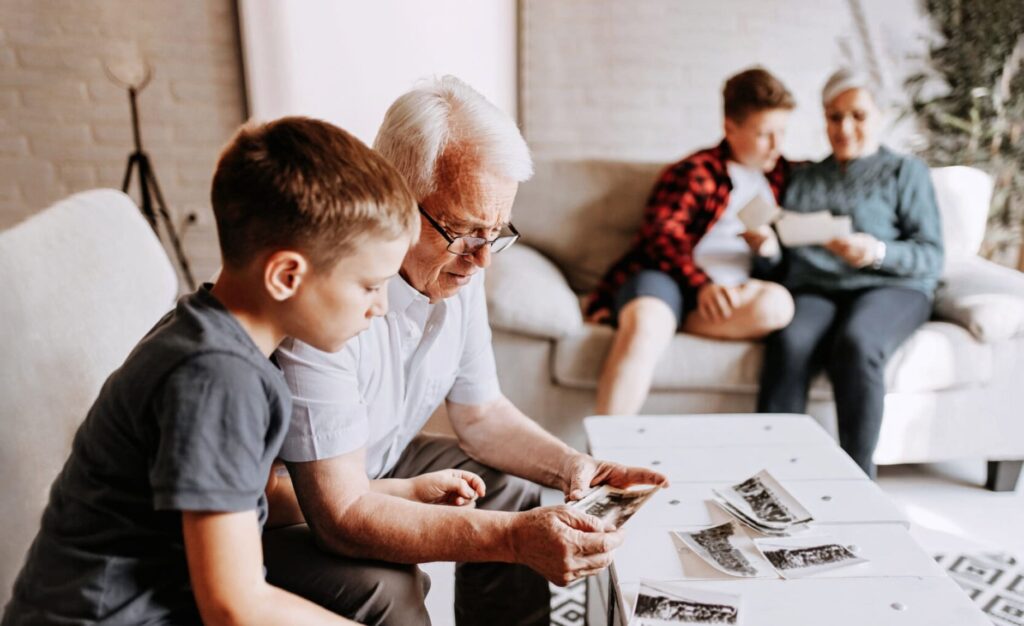 grandparents and grandkids sitting around looking at old photos