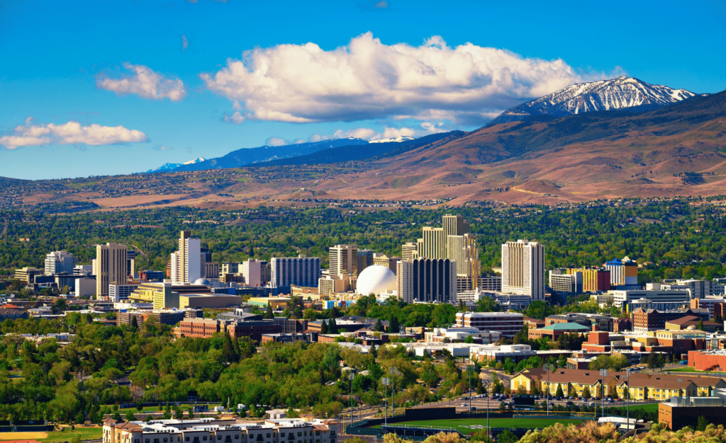 a photo of downtown reno with the mountains seen prominently behind