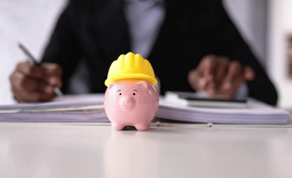 Piggy Bank With Construction Hard Hat in front of a financial advisor. symbolizing the protection a fiduciary provides.